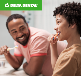 Father and son brushing their teeth together, good oral health improves your physical health too.